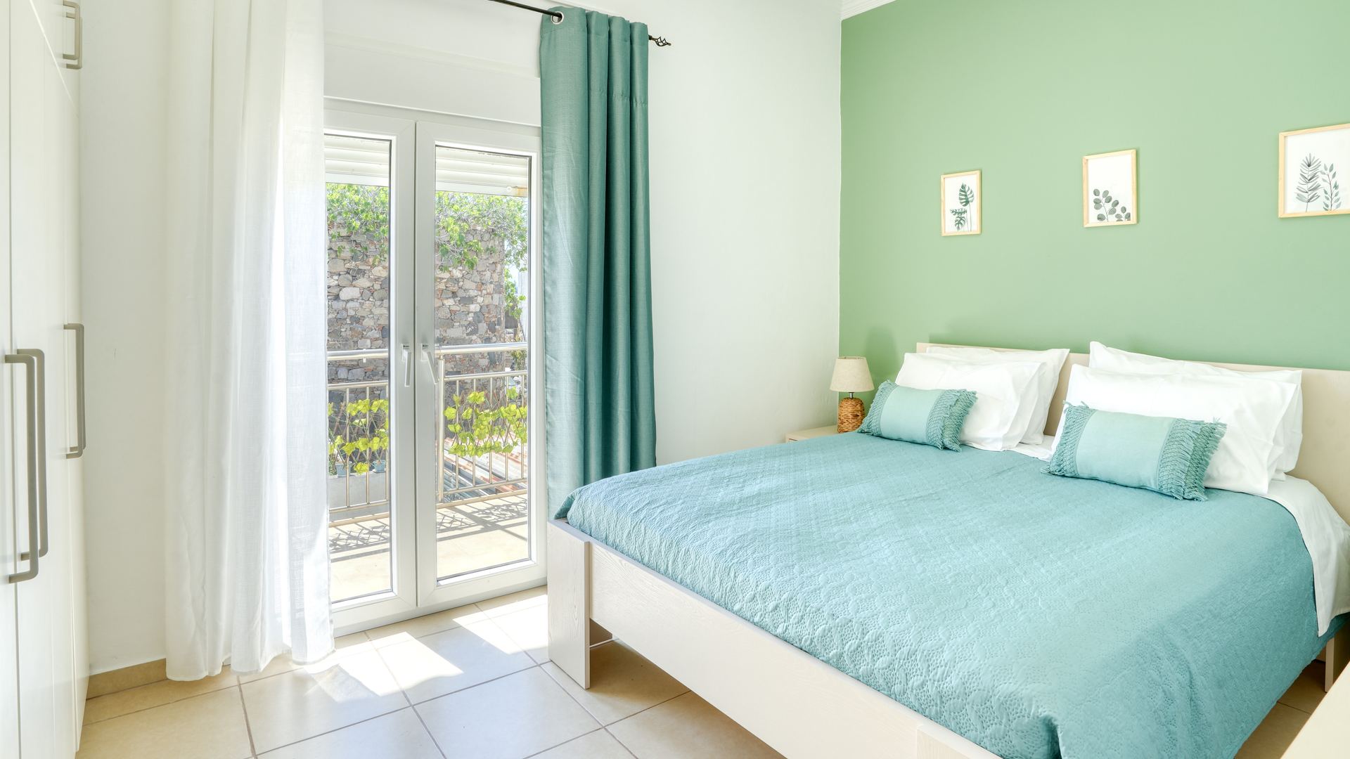 Double bedroom of The Three Sisters House Too with sage-green wall