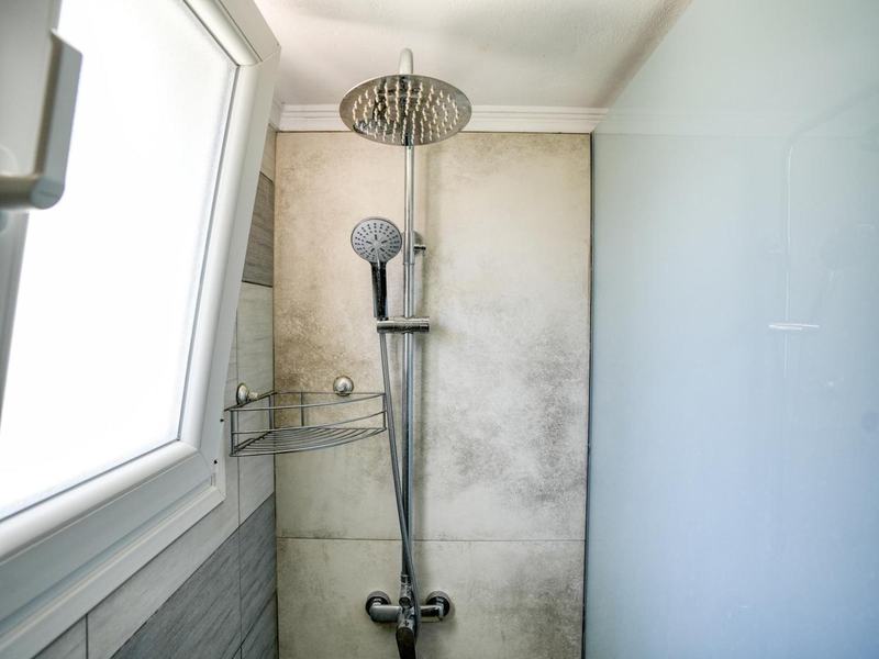 Rain shower with stone-effect tiles