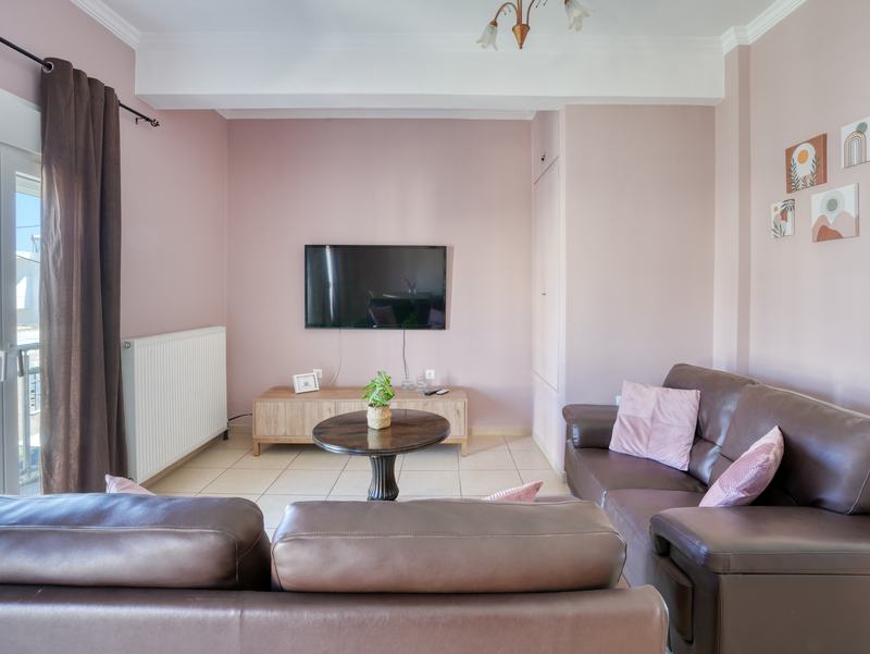 Living room with comfortable sofas and wall-mounted TV